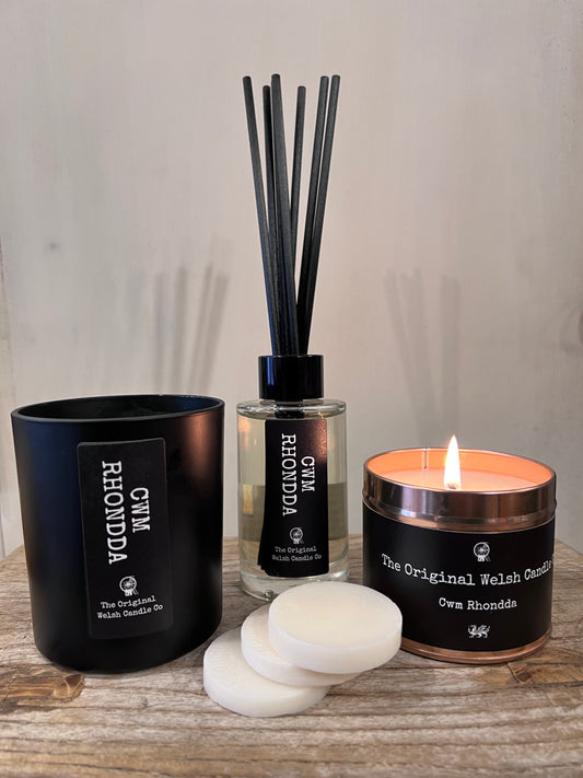 a lovely gift box containing a glass reed diffuser, a matt glass jar containing a scented candle a pack of wax melts and a copper tin candle all scented with fresh linen