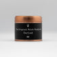  a copper tin with a black label saying CARIAD the welsh word for sweetheart, contains a scented candle with black pomegranate fragrance