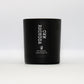 a matt black glass jar with a label saying CWM RHONDDA, filled with a luxury soy scented candle